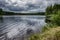 The lake is surrounded by a thick forest along the perimeter