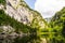 Lake Toplitz in Austria surrounded by green hills under the cloudy sky