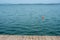 Lake Trasimeno, lake landscape with a red buoy seen from a pier