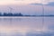 Lake with two Bladed Wind Turbines, or modern Windmills, in a Wind Farm along the nature reserve Eemmeer in the