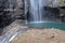 Lake under Madakaripura waterfall with beautiful turquoise water. The water flows from the pond.