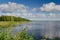 Lake Vaskilampi Finland blue sky white clouds coniferous forest landscape