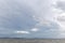 Lake with very white clouds over an island