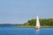 Lake view with sailboat and trees at the lake Schaalsee in Seedorf, Germany