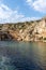 Lake Vouliagmeni in Athens is surrounded by steep cliffs