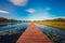 Lake water, pontoon, blue sky, white clouds, grass, reflection, autumn