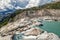 Lake and waterfall on rhone glacier between swiss alps