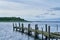 Lake with wetlands and old weathered pier in the evening