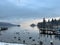 Lake Windermere, Lake District in England. Winter with snow. Calm still water with birds boats and swans