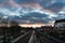 Laken, Brussels Capital Region - Belgium - Colorful clouds over the railway tracks at the local metro and train stop Pannenhuis -