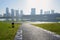 Lakeside asphalted pedestrian way on grassy lawn in summer morning