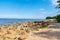 lakeside beach details with sand, rocks and blur background