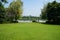 Lakeside lawn with family on bikes at shore in background