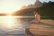 Lakeside love. an affectionate young couple in swimsuits sitting on a dock at sunset.