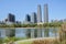 Lakeside path at park in modern city on sunny summer day