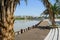 Lakeside planked path and stone stairway in city of sunny summer