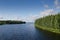 LakeVaskilampi Finland blue sky white clouds coniferous forest landscape