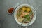 `Laksa Sarawak` is local dish famous in Sarawak Malaysia. Serve in white bowl over cement background