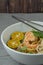 `Laksa Sarawak` is local dish famous in Sarawak Malaysia. Serve in white bowl over cement background