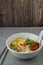 `Laksa Sarawak` is local dish famous in Sarawak Malaysia. Serve in white bowl over cement background