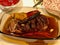 Lamb Arm Tandoori / Tandouri Food in Glass Bowl at Dinner Table.