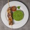 Lamb brochette marinated in spices, green semolina