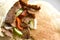 Lamb doner kebab with cucumber, tomatoes and onion in pita bread.