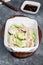 Lamb dumplings in a deep white plate on a gray background