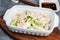 Lamb dumplings in a deep white plate on a gray background