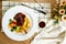 Lamb Ossobuco or Osso buco lamb shanks with potato, dip, knife, fork and salad served on plate isolated on napkin top view of meat