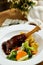 Lamb Ossobuco or Osso buco lamb shanks with potato, dip and salad served on plate isolated on napkin side view of meat food