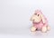 Lamb plush toy. White and pink lamb. Gray background.