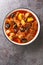 Lamb, prune and potatoes ragout closeup in the bowl. Vertical top view