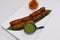 lamb seekh kebab (mince mutton meat skewer) served with mint chutney, indian street food