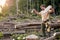 lamberman is splitting firewood up while chopping it with an ax, dividing