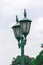Lamp mounted on a green pole