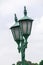 Lamp mounted on a green pole