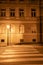 A lamp near pedestrian crossing on a deserted night street in Prague, Czech Republic