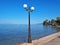 Lamp post on Nikolaiika Beach and the Corinthian Gulf in Greece