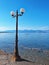 Lamp post on Nikolaiika Beach and the Corinthian Gulf in Greece