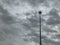 Lamp post or street light with rain cloud coming in sky before storm for background