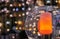 Lamp with a round plafond and an orange candle on a bokeh background