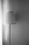 Lamp with soft side light in black and white and a wall as background