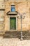 A lampost in front of an old stone building in the medieval hill town of Montalbano Elicona