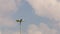 Lamppost against the sky. Clouds running through blue sky. Time-lapse recording. A looped clip with no breaks