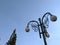 A lamppost with garden round lamps on sky background