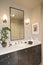 Lamps By Mirror Over Washbasin In Bathroom