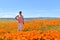 Lancaster, Ca / April 12, 2019 - Admiring the golden poppies in full bloom covering the hillsides in the Antelope Valley with brig