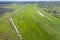 Land improvement or land amelioration concept, drone flying over narrow irrigation or drainage channels on rye or wheat field.