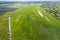 Land improvement or land amelioration concept, drone flying over narrow irrigation or drainage channels on rye or wheat field.